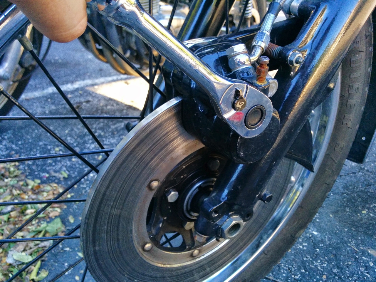 Unscrewing bolts from disc brake caliper